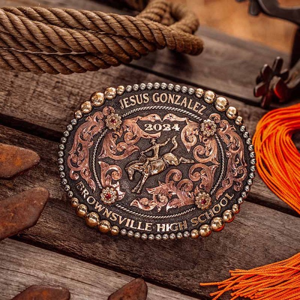 A custom rodeo belt buckle for Brownsville High School with personalized name featuring a golden bronze bronc rider cowboy figure 